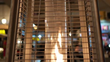 pedestal up shot of a fire pit - street gas heater in a busy street