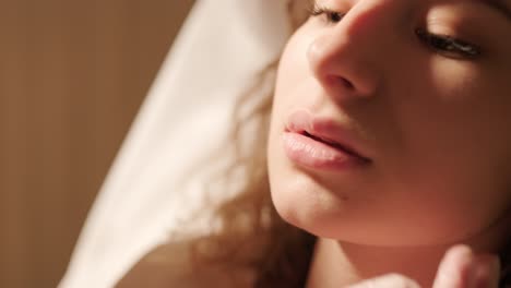 close-up of cosmetologist's hands examining lips