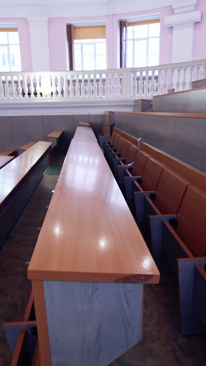 Inside university lecture hall with nobody inside. Interior of big auditorium. Vertical video
