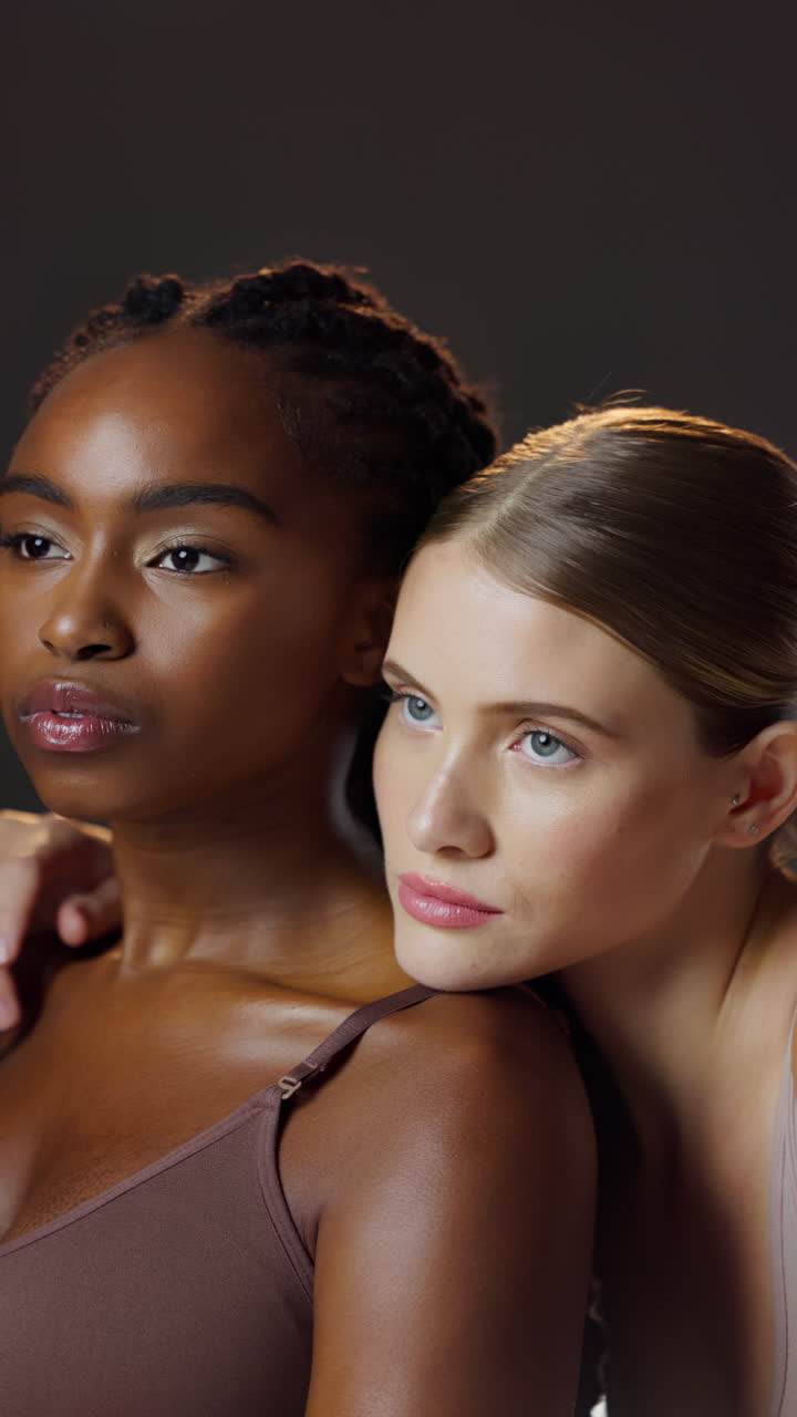 Two diverse women posing closely together