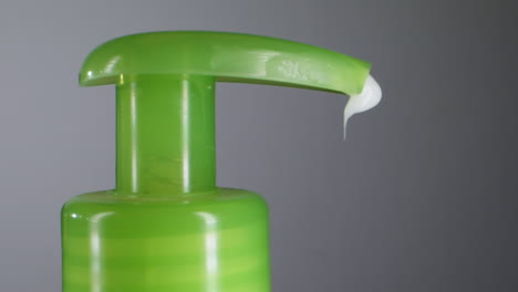 squeezing a white moisturizer from a tube close-up mcaro. morning routine. beauty, cosmetic and care concept.