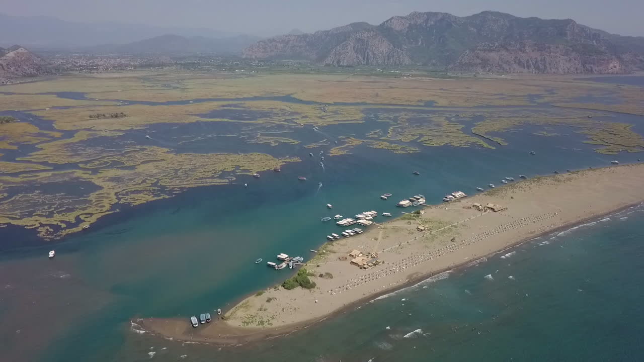 Turkish Iztuzu Beach forms beyond shallow river estuary at Dalyan