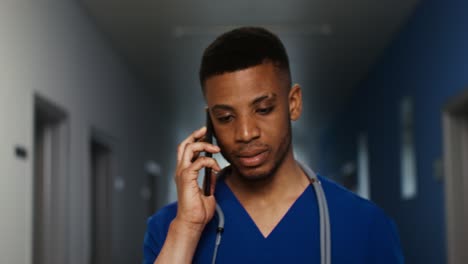 doctor on phone call in hospital hallway