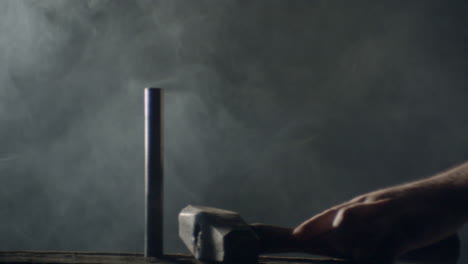 hammer hitting a big nail in a dramatic misty ambience