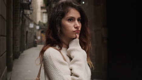 Thoughtful-woman-on-narrow-street