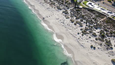 Drone-aerial-over-an-old-deconstructed-pier-on-a-pristine-beach