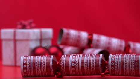 christmas cracker spinning and bouncing beside present and bauble