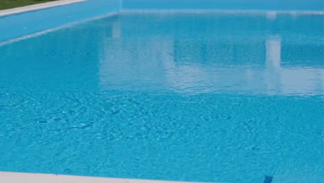 pure blue water in pool with light reflections. slow motion.