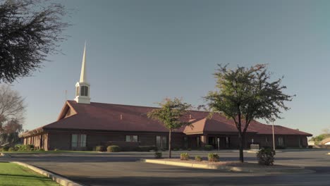 white spire mormon church building during sunrise with slow zoom out