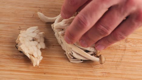 chef cutting bunashimeji mushrooms