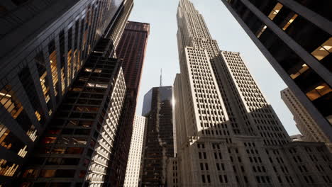 tall skyscrapers towering over a new york city street during bright daylight