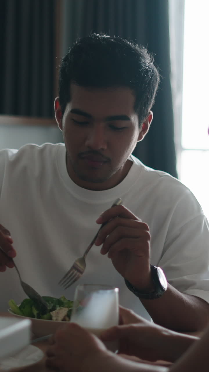 Man Eating Salad with Couple