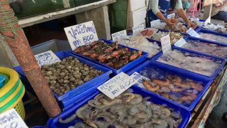 various seafood displayed in a busy market