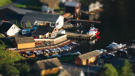 a small tidy harbor in the village of herand with boats standing at the dock and neat boathouses