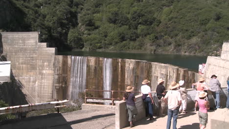 side view of water spilling over the matilija dam during a guided tour in ojai california