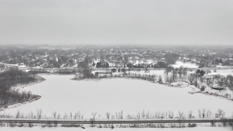 Dramatische-Luftaufnahmen-über-Dem-Lake-Cornelia-Edina,-Minnesota,-Nachdem-Starker-Schneefall-Die-Landschaft-In-Ein-Winterwunderland-Verwandelt-Hat