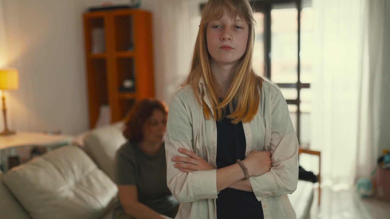 Frustrated teen daughter arguing with mother at home