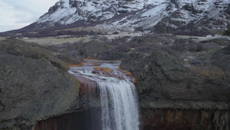 amazing salto del agrio waterfall plunging into a rocky patagonian canyon with aqueous mist rising, neuquén, argentina