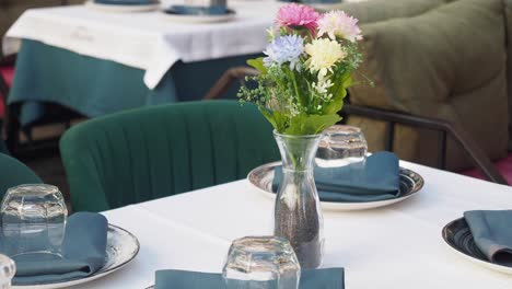 outdoor restaurant table setting with flowers