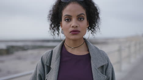 portrait-of-beautiful-hispanic-woman-looking-intense-confident-standing-on-seaside-beach