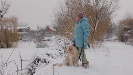 woman and her dog enjoying a winter day in the countryside