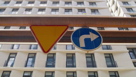 two road signs on the building