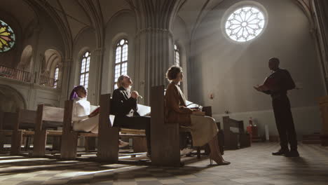 african clergyman preaching sermon to parishioners