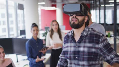 Diverse-group-of-business-colleagues-using-vr-headset-during-meeting