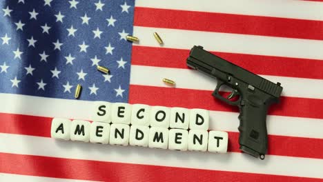 second amendment concept with handgun, bullets, and american flag