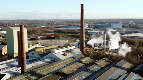 pilkington glass factory warehouse buildings aerial view orbiting industrial chimney rooftop