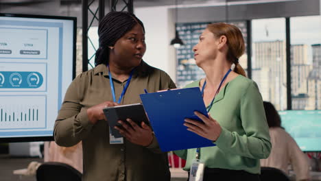 vertical video collaborative team of professional women reviews key data and reports