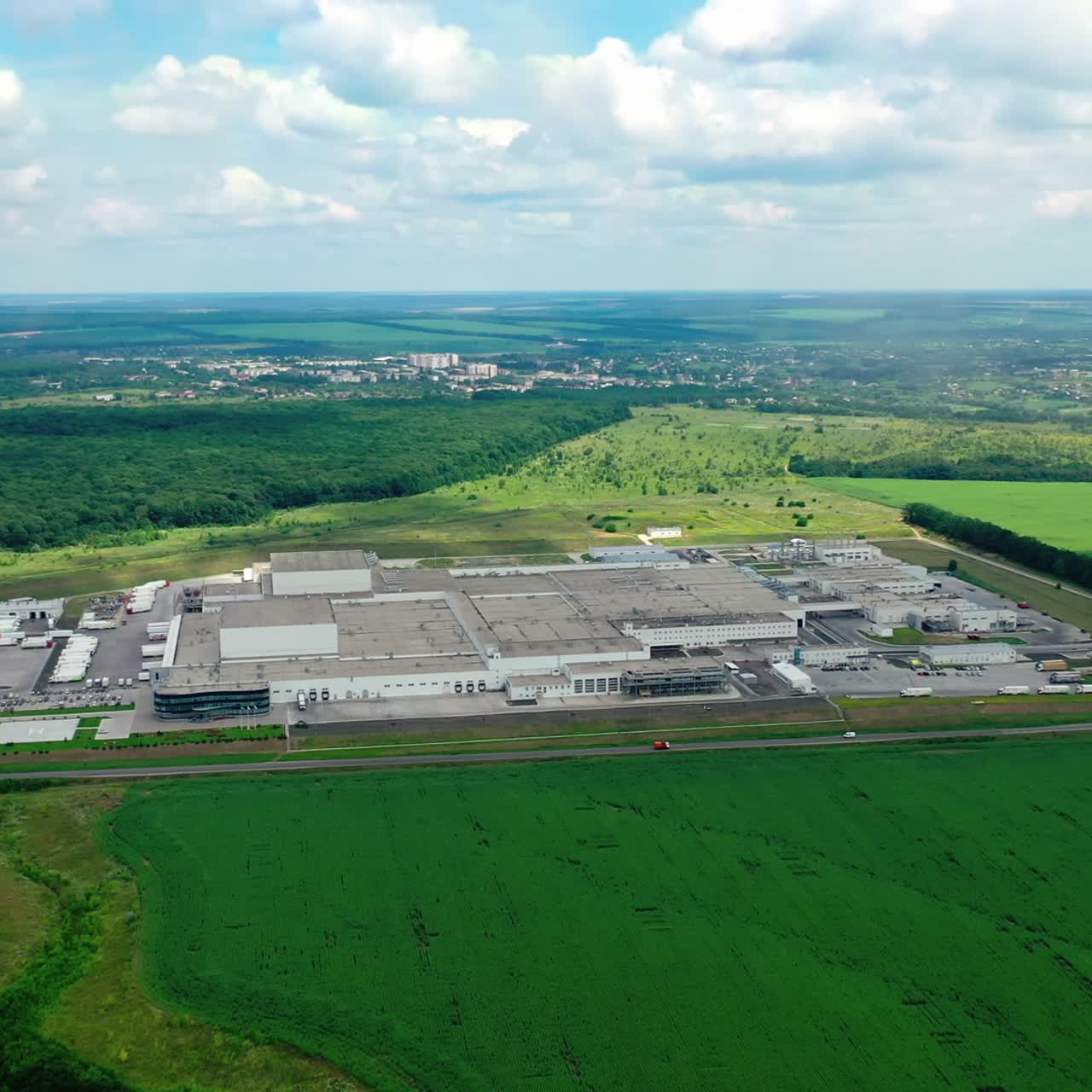 Large factory in nature. Panoramic view on industrial complex in the countryside. Industrial territory on green field. View from the air