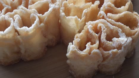 detailed zoom in shot of a traditional spanish fried sweet known as flor frita, sprinkled with sugar