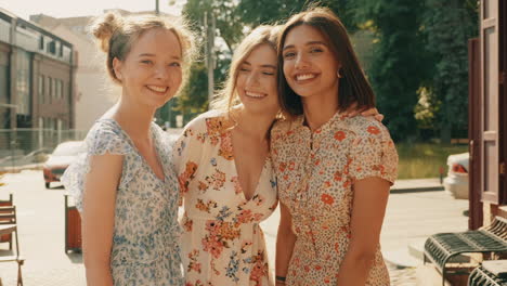 three happy women friends outdoors