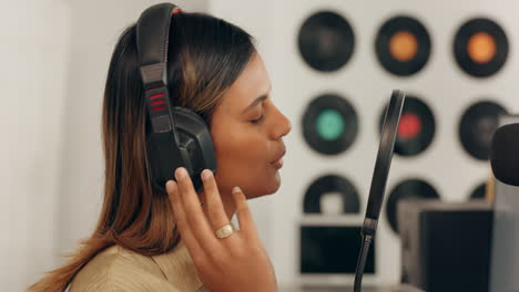 Headphones, microphone and woman singing
