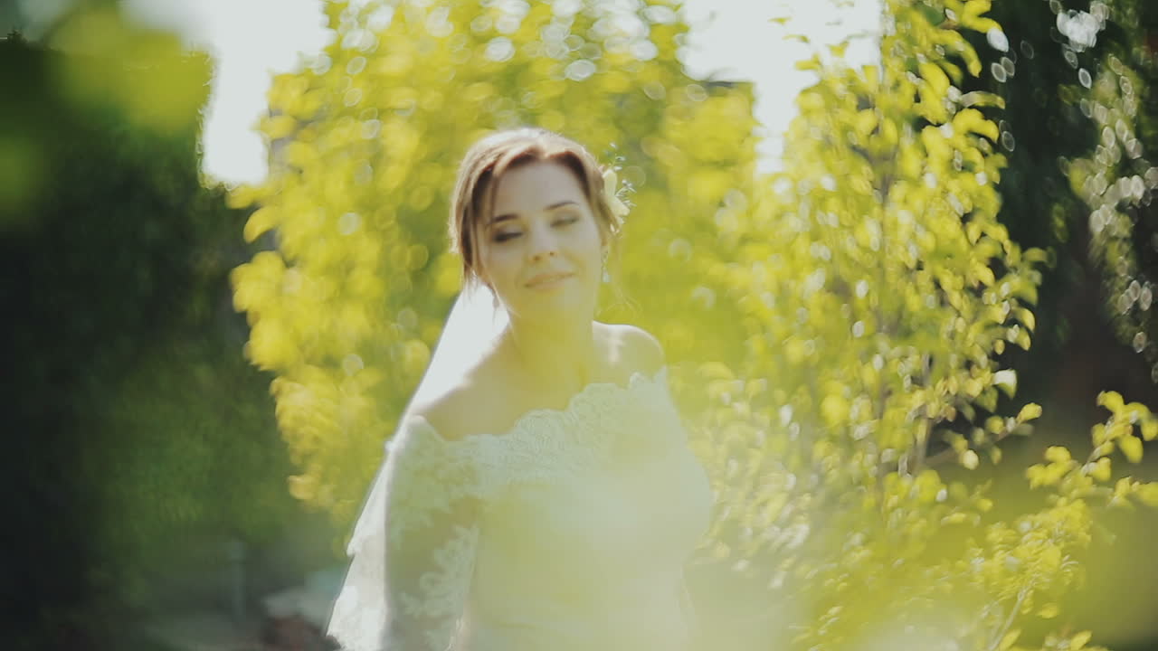 Elegant bride walks, spinning at the castle. Walking in the open air