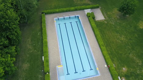 drone flying high above an openair swimming pool in leipzig half rotating and tilting down