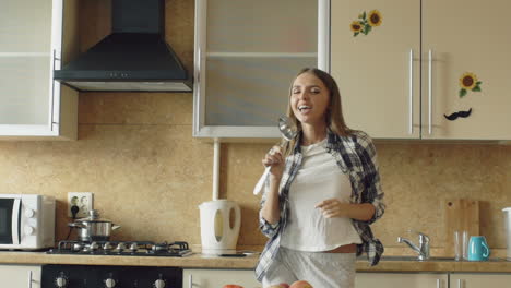woman singing in kitchen