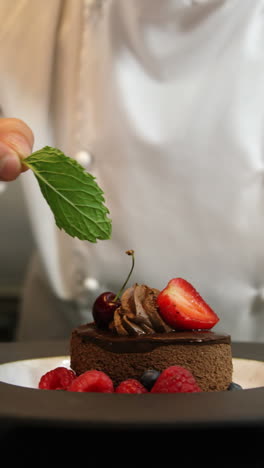 chefs putting finishing touch on desserts