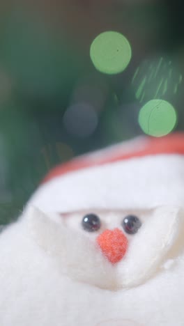 close-up of a santa claus decoration with festive bokeh lights