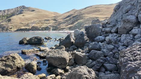 a tranquil coastal area in crimea showcases clear waters and sunbathers relaxing on a beautiful summer day