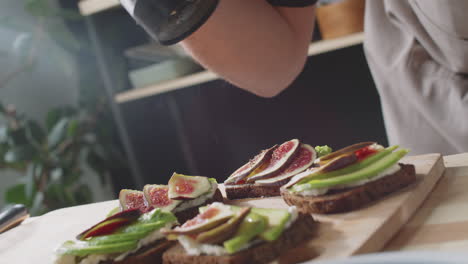 preparing delicious fig and avocado toast