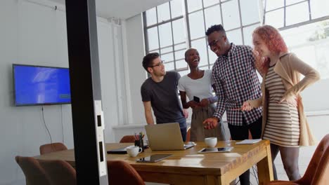 Front-view-of-young-mixed-race-business-team-planning-and-standing-in-meeting-room-in-office-4k