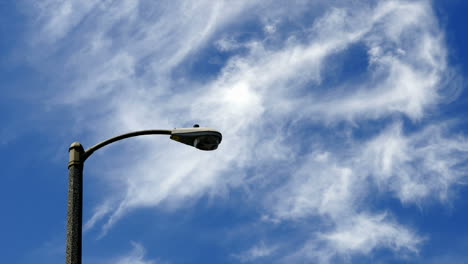 timelapse of clouds blowing by a light pole