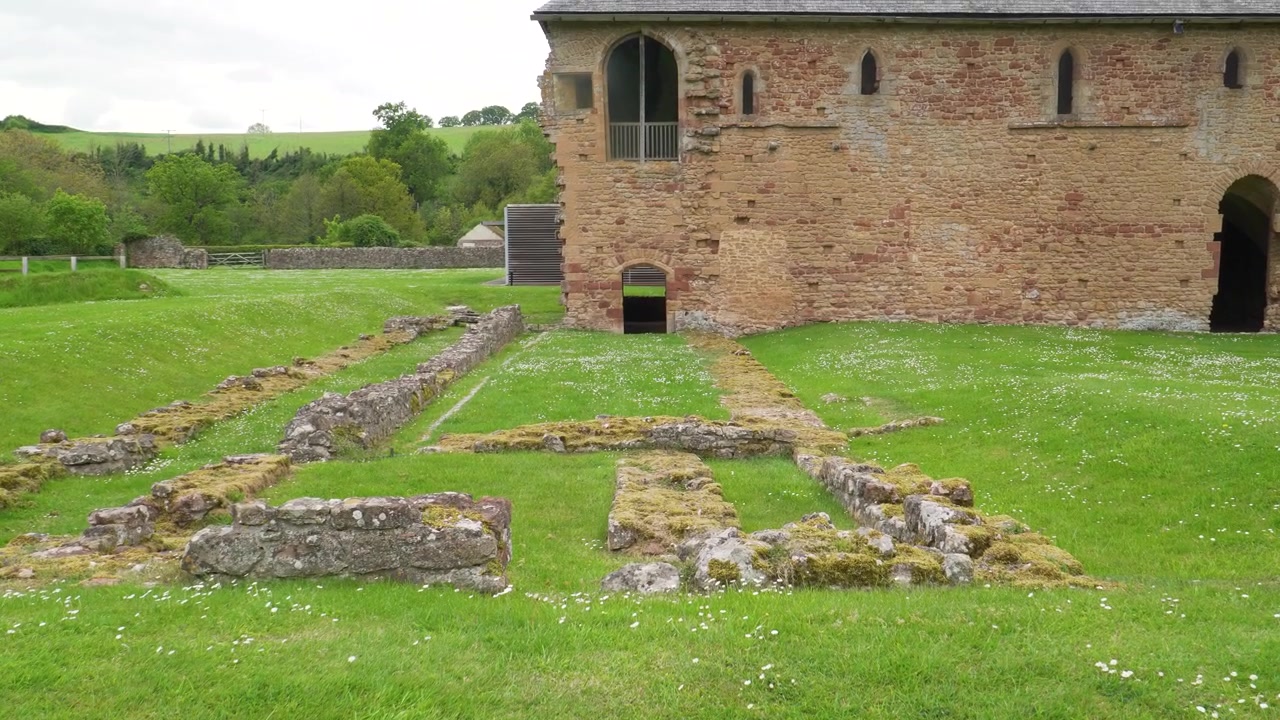 Dwaal door de sfeervolle overblijfselen van Cleeve Abbey en vang de essentie van het middeleeuwse leven met prachtige steenstructuren en een rustige landelijke omgeving. Camera beweegt omhoog.