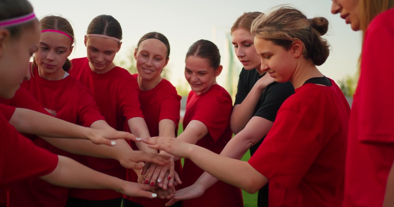 Young Female Soccer Players Showing Teamwork on the Field