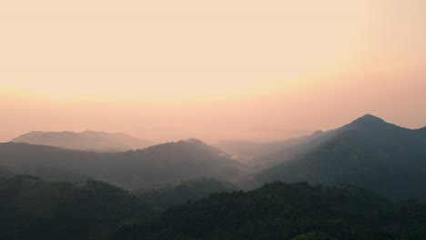 Aerial-view-of-mountains-peaks-with-fog-and-sunlight