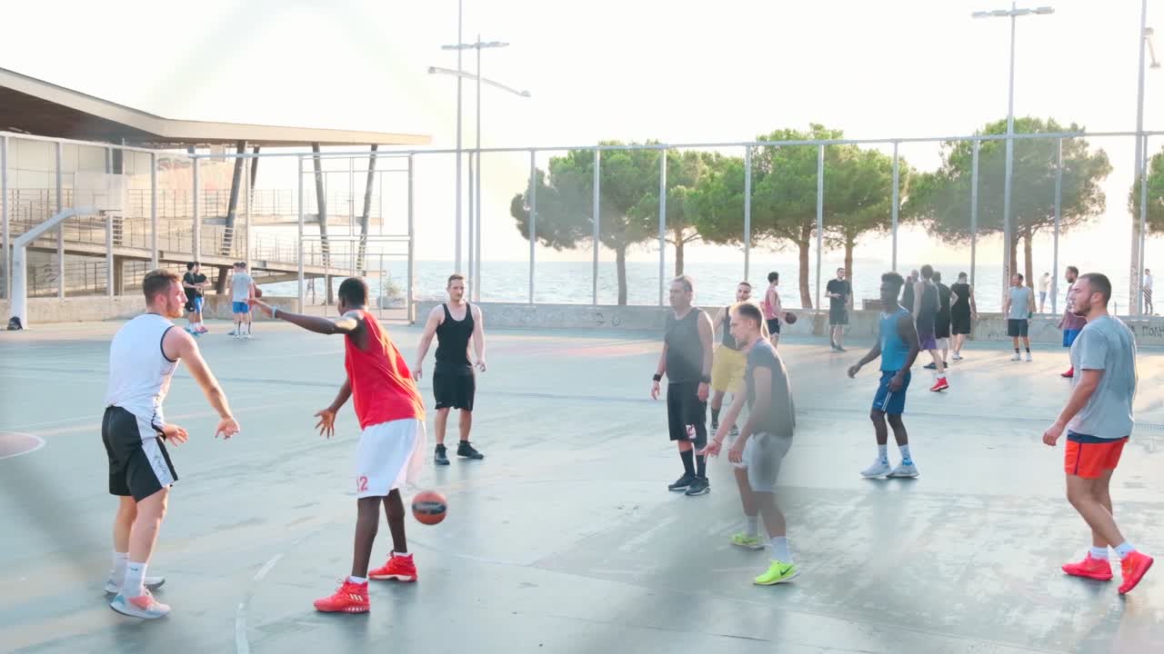 Adult People Playing Basketball At The Public Courts at the waterfront In Thessaloniki, Greece - Slow Motion