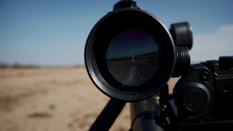 rifle scope in desert landscape