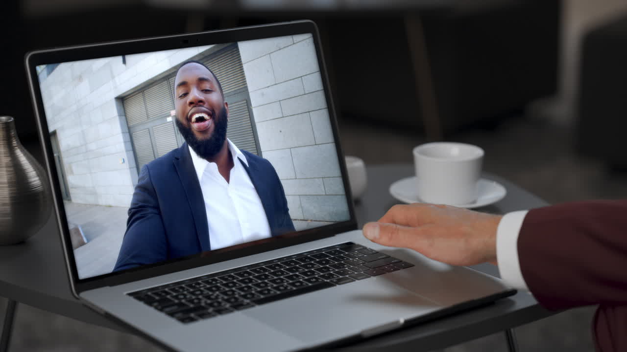 Business partners have video conference by laptop webcam shoulder view close up